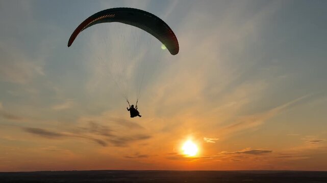 Tandem paragliding at the sunset