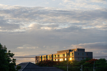 Fototapeta premium Modern residential building at sunset with sky background
