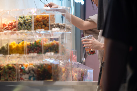 People Shopping for Candy in a Store Display