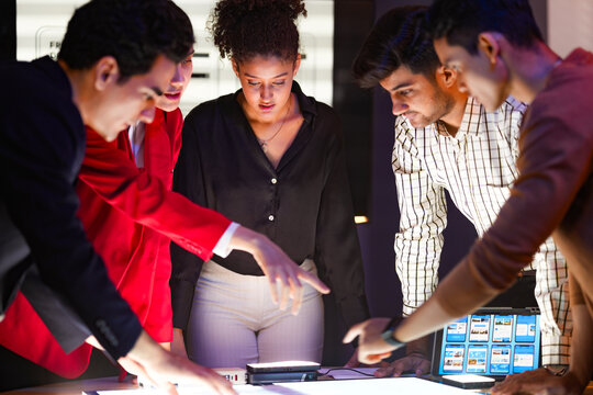 Lead designer presenting mobile application interface prototypes and front-end development layouts to the product development team.