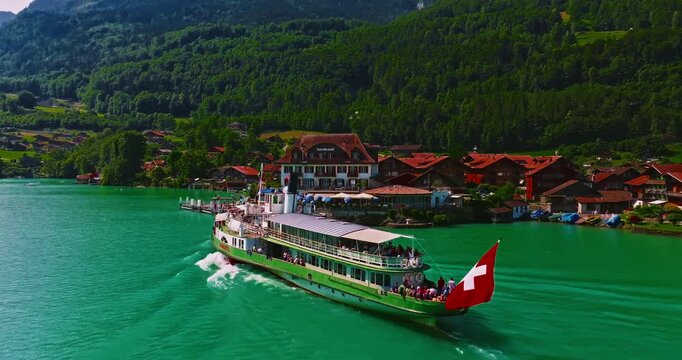 Aerial view of steamboat ship in lake with Swiss Flag. Beautiful Swiss Alps nature in summer Switzerland with turquoise blue lake water