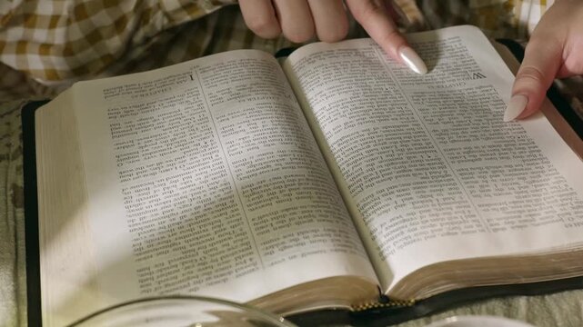 young conservative asian Woman Reading the Bible at table with bread food and drink indoors