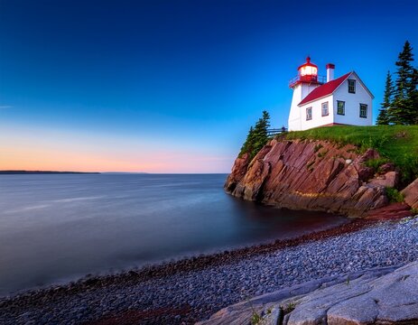 the beautiful musquash head lighthouse at dusk that overlook the coast over bay of fundy st john new brunswick canada