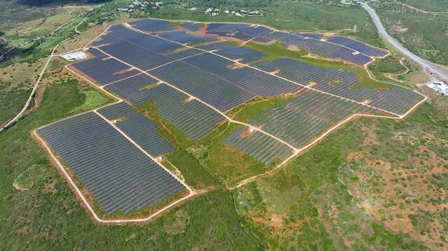 Solar power plant generates renewable energy using photovoltaic panels in open landscape for clean electricity production
