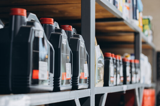 Car engine oil containers on workshop shelves