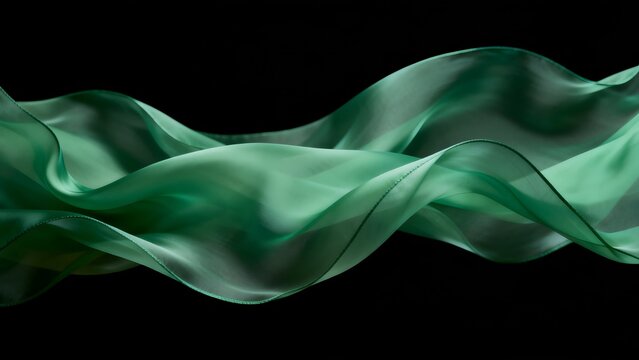 Green fabric flowing against black background
