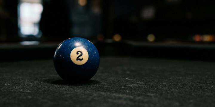 Close-up of a blue pool ball on a table