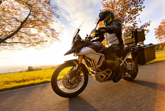 Driver riding motorcycle on empty road