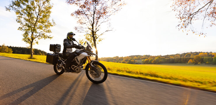 Driver riding motorcycle on empty road