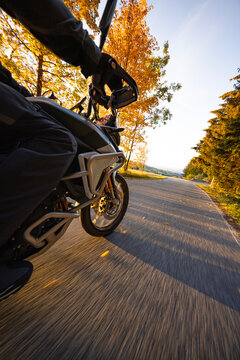 Driver riding motorcycle on empty road