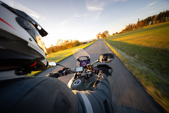 Driver riding motorcycle on empty road