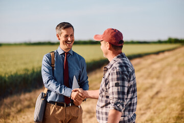 Happy insurance consultant came to agreement with farm owner. © Drazen