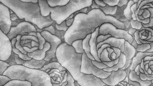 Top view of gray fleece blanket with embossed rose flower pattern texture, soft fabric surface background for winter bedding, monochrome closeup.