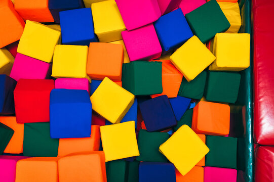 A backdrop of colorful foam blocks in the children's room. Soft toys for comfortable relaxation.