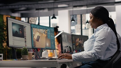 Fototapeta premium African american architectural developer working with remodeling software for apartment layout, interior design program on computer.