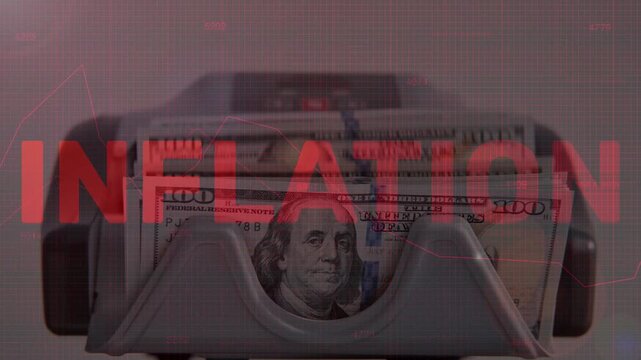 Money counting machine rapidly flipping US 100 dollar bills with a large red "INFLATION" text overlay and background charts. Symbolizes currency devaluation and economic crisis.