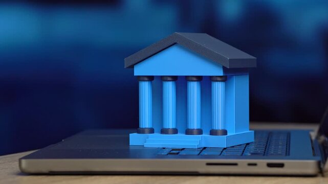 A bank figurine on a laptop. Online banking concept. Financing solutions for business. Credit access, restructuring, and capital management support growth and stability