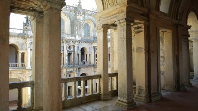 Tomar, Portugal - August 10, 2017: corridor pov inside Claustro da Lavagem with azulejos in Templar Castle of Tomar or Convent of Christ on blue sky. Unesco Heritage and popular place.