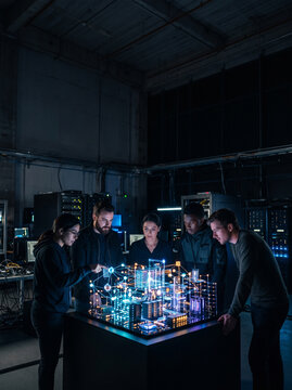 Data center engineer network server ai framework trustworthy team studies glowing smart city model in dark control room