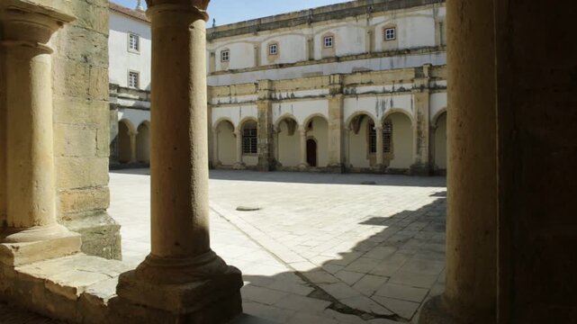 Tomar, Portugal - August 10, 2017: pov in corridor inside small Claustro de Santa Barbara in Templar Castle of Tomar or Convent of Christ. Unesco Heritage, originally a fortress of the Knights Templar