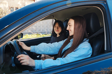 Naklejka premium Happy women riding car together, view through window