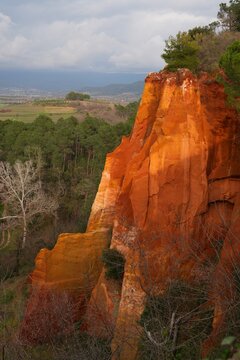 View of red and yellow ochre cliffs outside the town of Roussillon in Vaucluse, Provence, France