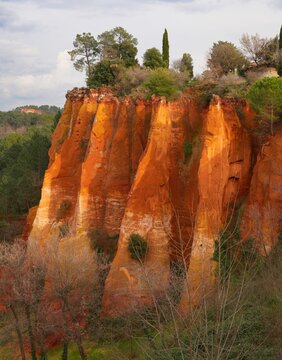 View of red and yellow ochre cliffs outside the town of Roussillon in Vaucluse, Provence, France
