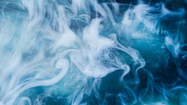 White ink spreading in blue water and creating an abstract smoky effect background. Billowing smoke clouds dissolving in liquid