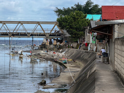Traditional outrigger boats moored along a canal in Dumaguete