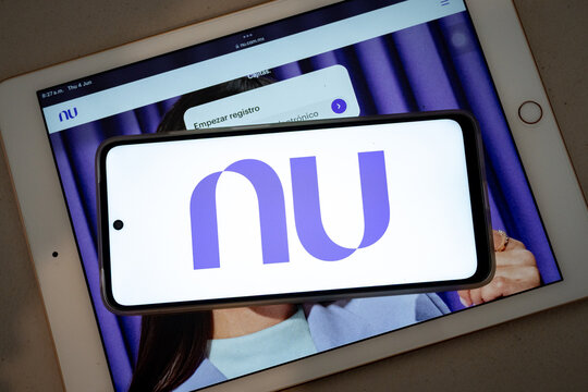 Mexico city, mexico, 06 04 2026, nubank logo on smartphone over tablet displaying banking app