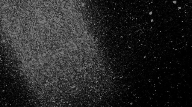 Grainy monochrome texture fading into darkness, featuring scattered speckles and atmospheric visual depth.