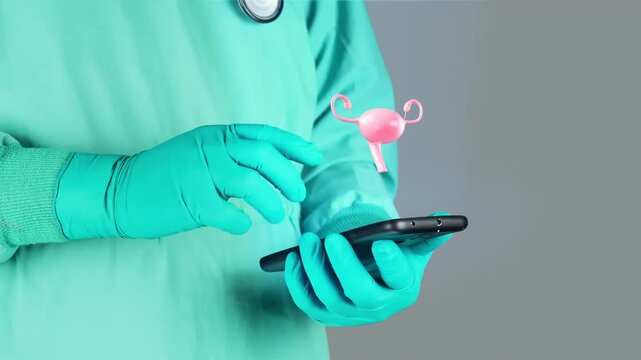 Doctor in emerald green uniform uses mobile device with 3D hologram of the uterus, technology-assisted gynecological diagnosis concept, digital health, medical diagnosis and precision medicine.