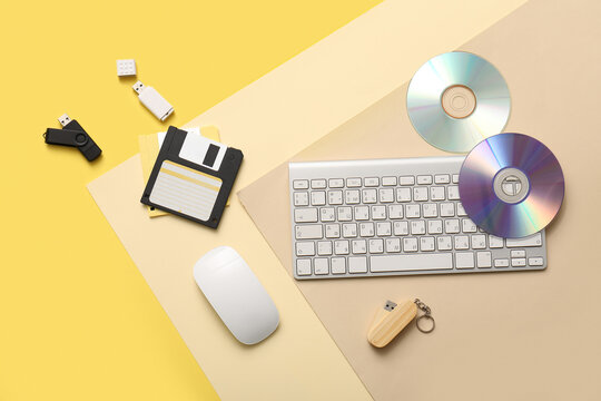 Retro and modern data storage devices with computer peripherals on yellow background