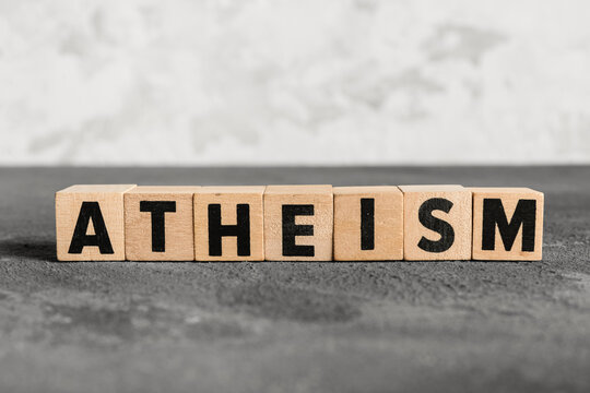 Atheism word on wooden blocks, belief system and philosophy concept, non-religious viewpoint, spirituality and humanism