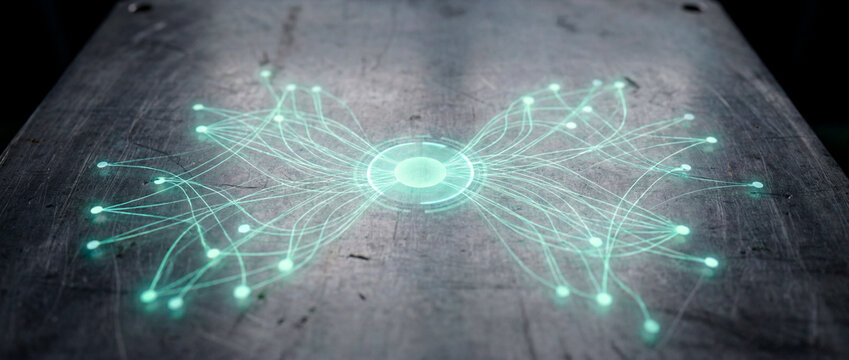 Symmetric green network lines radiating from central glowing disc on metal table