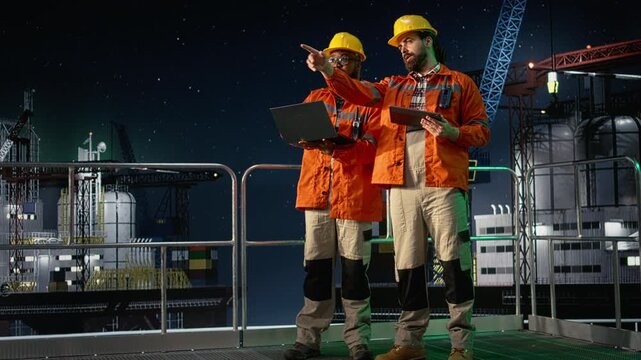 Portrait of smiling offshore platform coworkers monitor fuel shortages caused by embargo slowing operations with offshore platform context.
