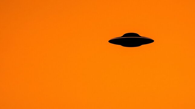 Sharp black UFO silhouette against a vibrant electric orange sky background