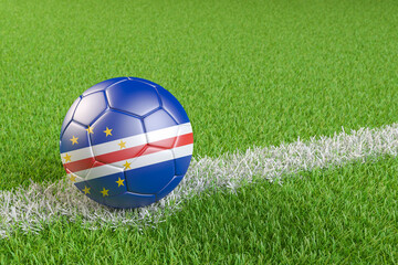 Obraz premium Football / soccer ball with a flag overlay of Cape Verde on a football pitch background. International match and national team of Cape Verde concept