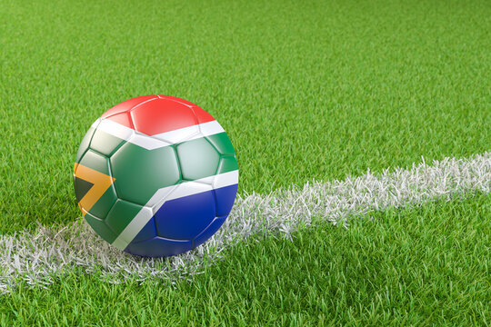 Football / soccer ball with a flag overlay of South Africa on a football pitch background. International match and national team of South Africa concept