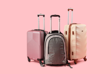 Different suitcases on pink background