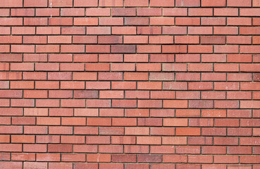 Fototapeta premium Full frame background of smooth red bricks arranged in parallel rows, minimalist industrial wall.