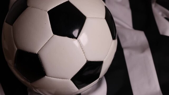 soccer ball and cleats on striped jersey (association football kit with shorts and boots) sports player gear competition playing play goal scoring