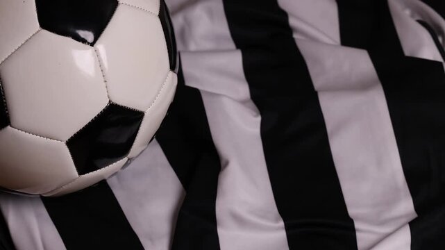 soccer ball and cleats on striped jersey (association football kit with shorts and boots) sports player gear competition playing play goal scoring