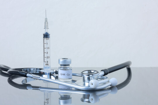 Professional clinical peptide therapy setup featuring sterile glass vial syringe and stethoscope offers hopeful health treatment