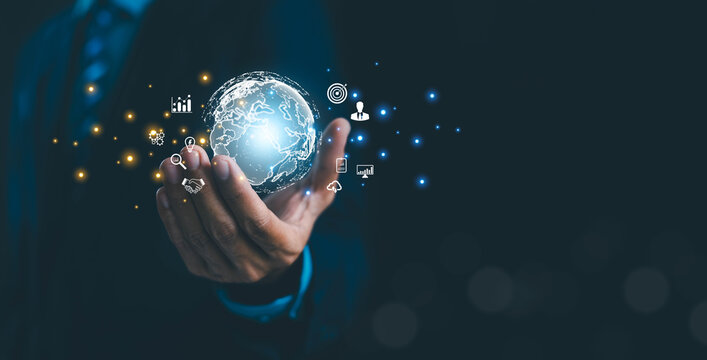 Global business technology concept featuring a digital world globe in a businessman&rsquo;s hand, symbolizing innovation, data analytics, cloud computing, digital transformation, global networking.