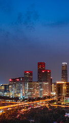 Obraz premium A panoramic night view of the core area of Beijing's CBD, showcasing the modern urban skyline of the Guomao skyscraper complex.