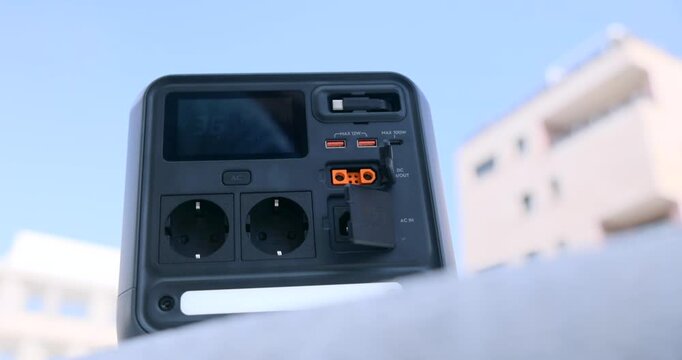 Portable power station sitting outdoors, providing essential electricity for various devices