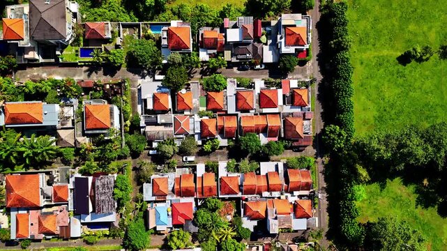 Residential neighborhoodi n Kuta Selatan, Bali with orange rooftops bordering a green field