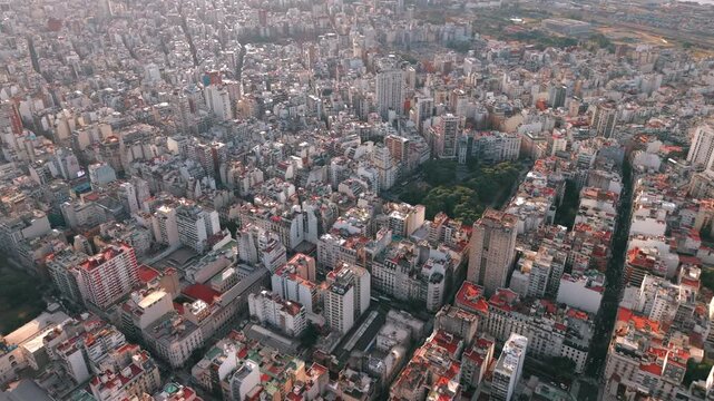 Plaza Vicente L&oacute;pez y Planes anchors the Recoleta district of Buenos Aires, Argentina, surrounded by elegant residential buildings, tree-lined streets and dense urban development, drone forward flyove