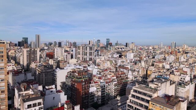 Central Buenos Aires extends toward the Catalinas Norte business district, revealing dense residential blocks, historic architecture and modern high-rise development, drone forward flyover shot.